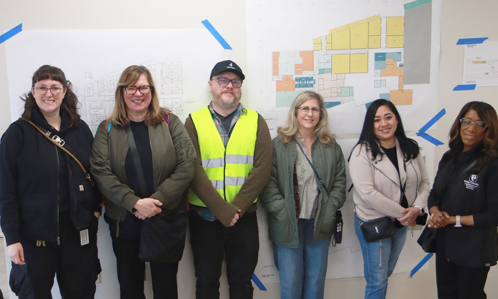 People standing in front of floor plans