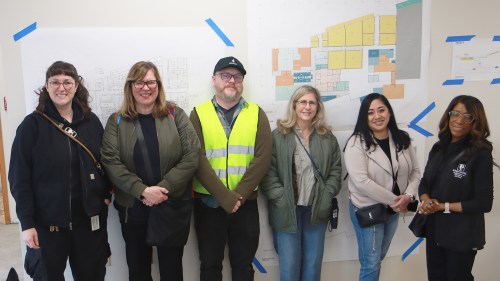 People standing in front of floor plans